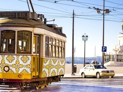 Vintage yellow tramway at the Commerce Square in Lisbon